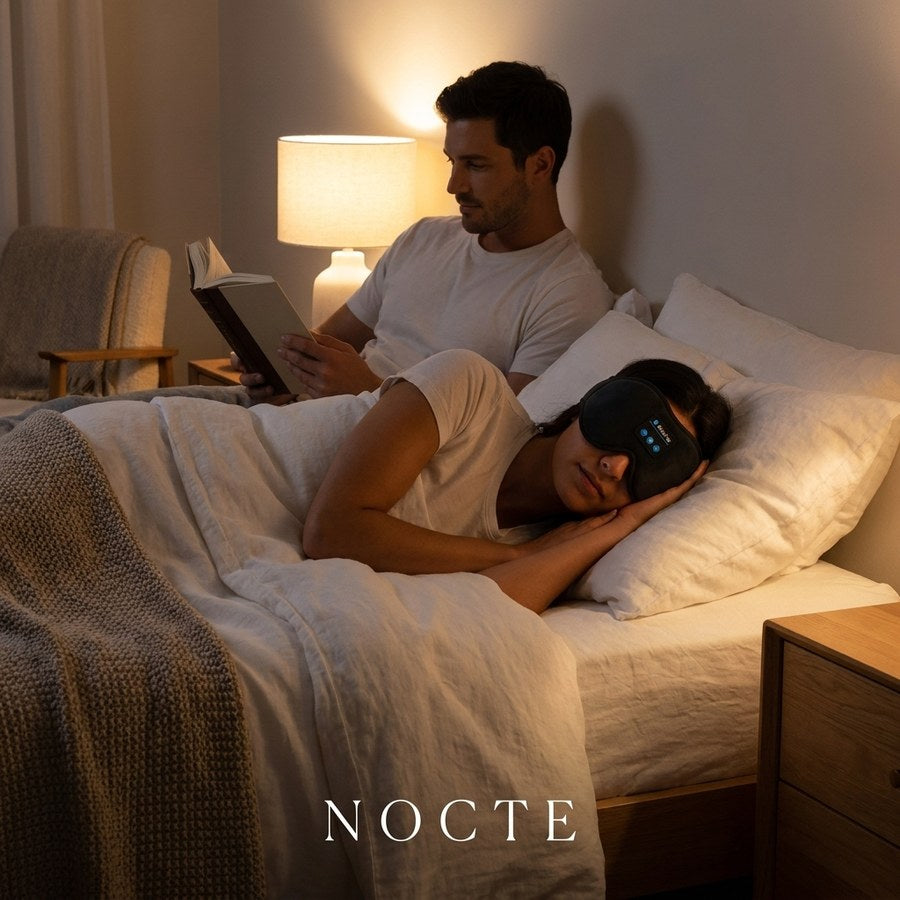 One partner asleep in the mask while the other reads