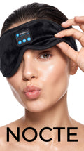The Nocte Sleep Mask in Midnight, lifted off one eye